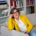 Eine Frau sitzt auf einem Sofa.